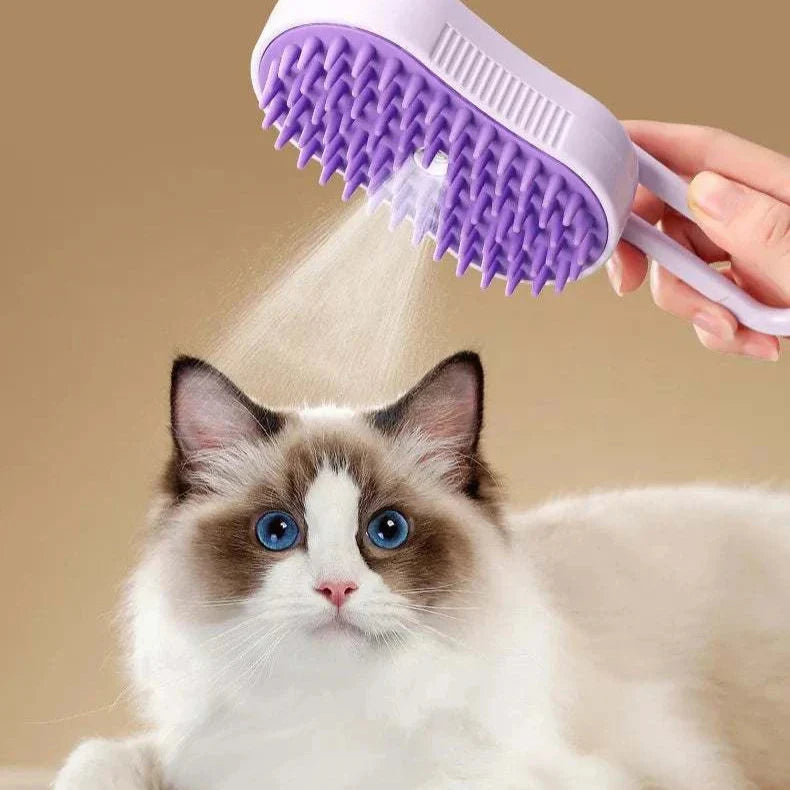 Purple Steam Pet Brush grooming tool spraying steam over a fluffy white and brown cat with blue eyes