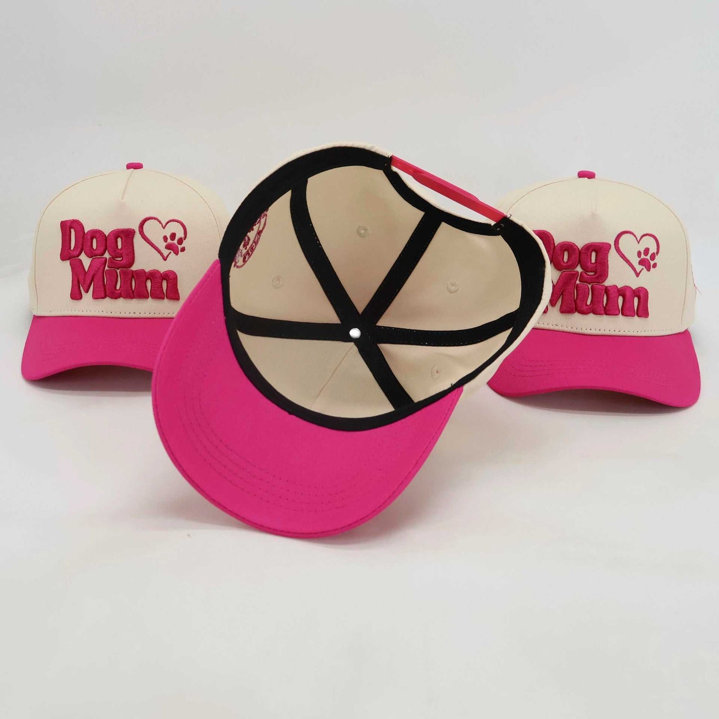 Adjustable pink and white embroidered baseball hats with "Dog Mum" design for pet parents