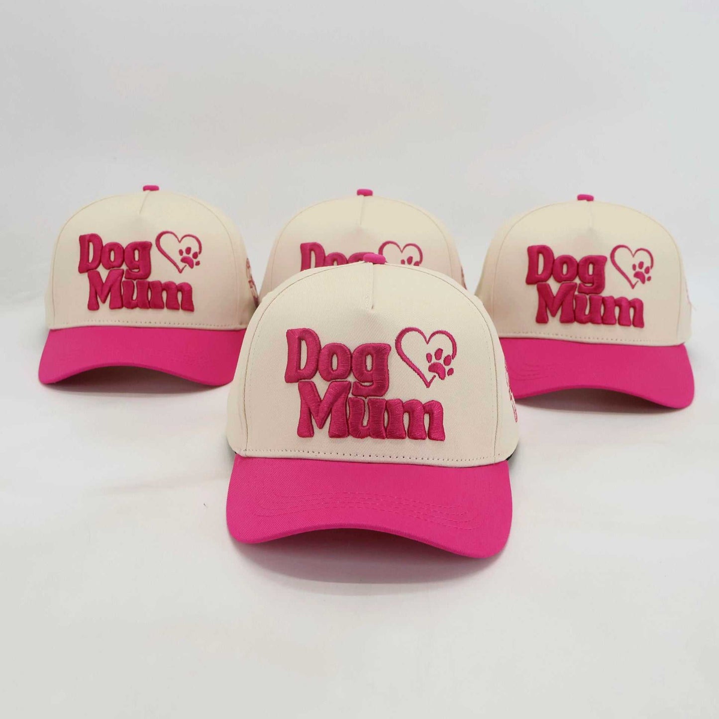 Baseball hats with Dog Mum embroidered design in pink and beige for proud pet parents
