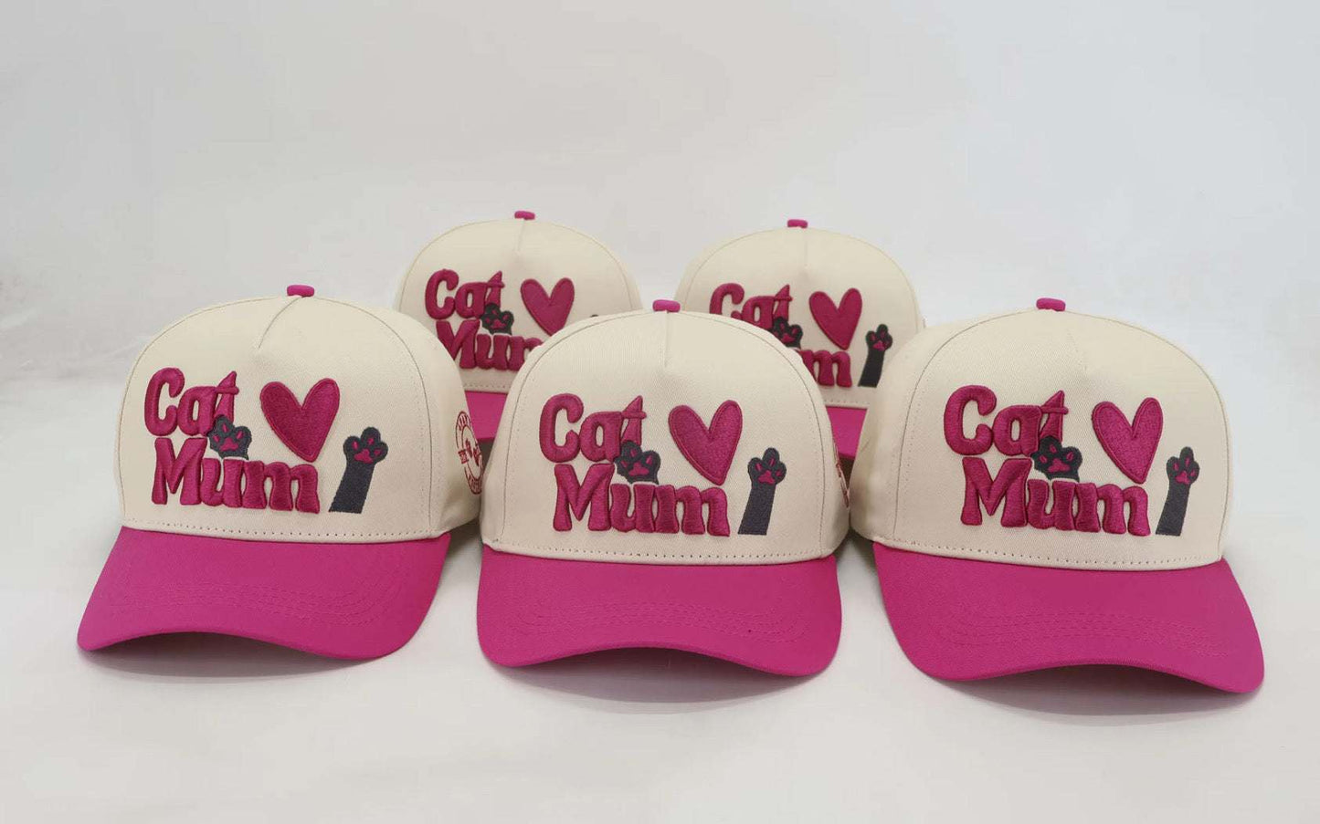 Adjustable baseball hats with embroidered "Cat Mum" design in pink and white, perfect for pet owners.