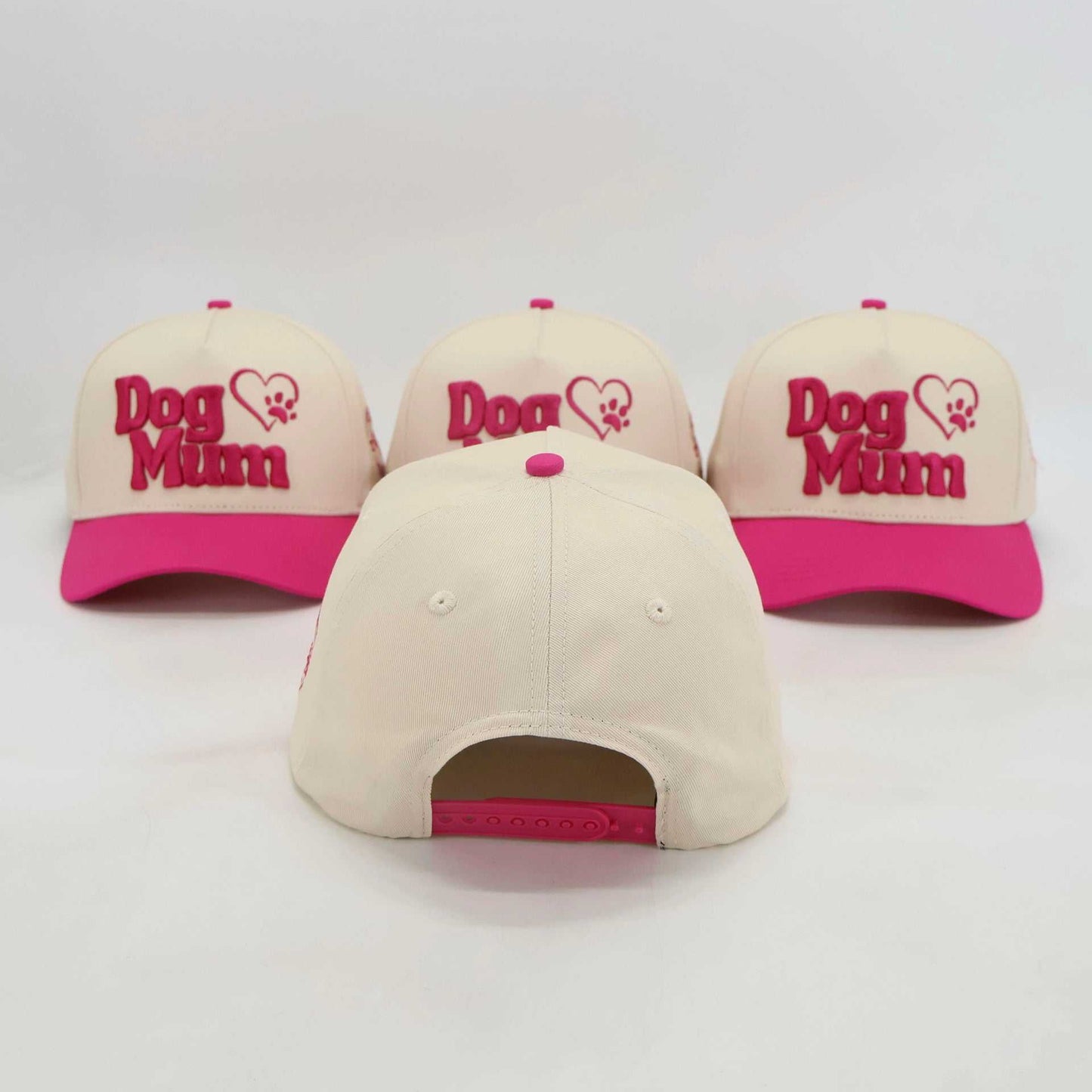 Adjustable beige and pink baseball hats with embroidered "Dog Mum" design for pet owners