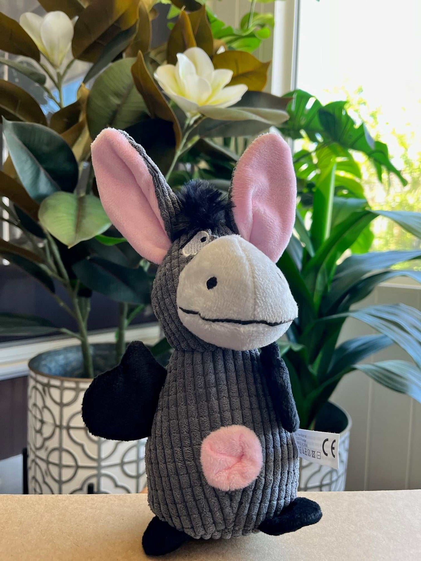Interactive plush toy donkey with squeaker, crinkle ears, and rope tail for small to medium dogs