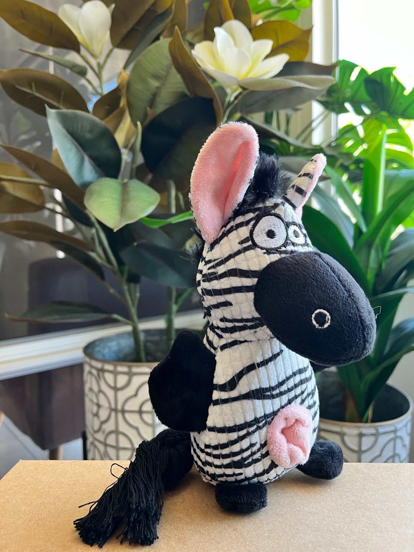 Small interactive plush toy zebra with squeaker, crinkle ears, and rope tail for dogs