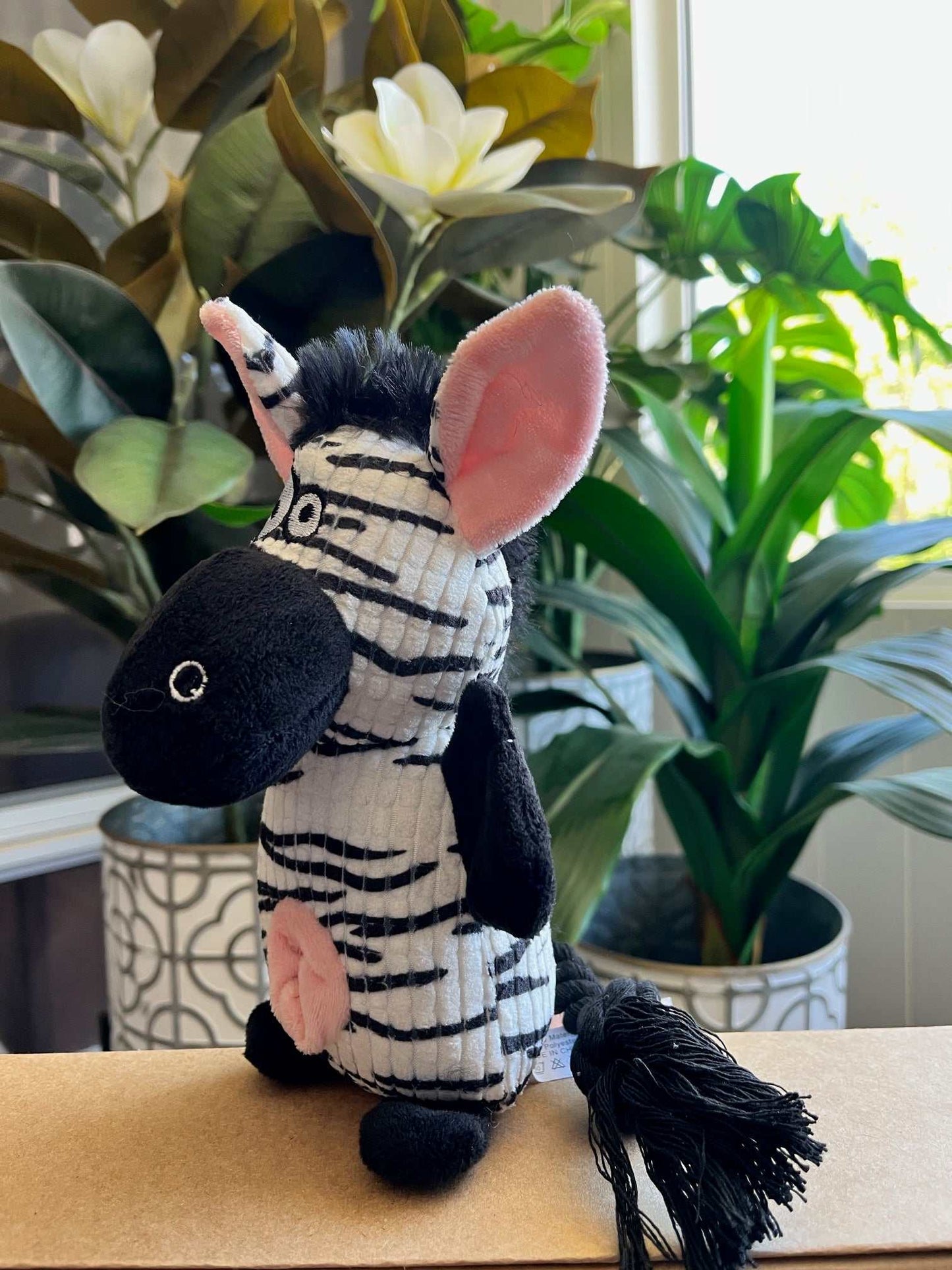 Small interactive plush toy zebra with squeaker, crinkle ears, and rope tail for small to medium dogs