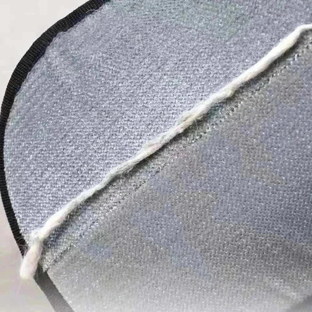 Close-up of eco-friendly Two-Way Pet Hair Removal Glove from Cat V’s Couch Defender Duo Bundle against gray couch fabric