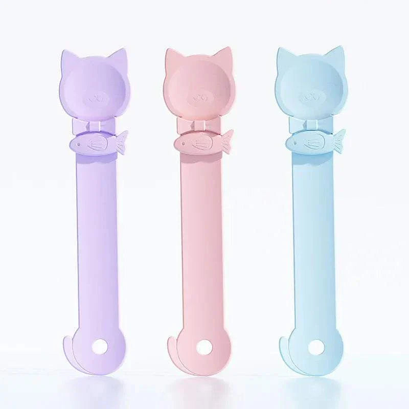 Colorful Cat Strip Spoon Feeders with cat-head handles and fish-shaped buckles for secure treat feeding
