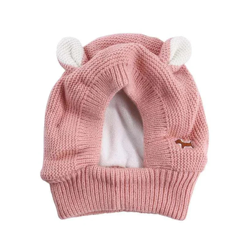 Pink knitted anxiety relief ear protection hat for medium to large dogs with noise-cancelling ear muffs and ear details