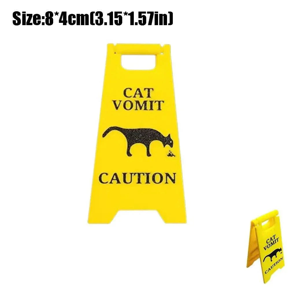 Bright yellow cat and dog vomit caution warning sign with humorous silhouette design
