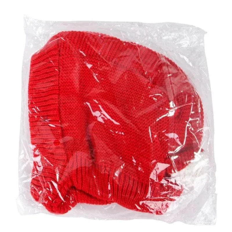 Red knitted anxiety relief ear protection hat for dogs in clear plastic packaging