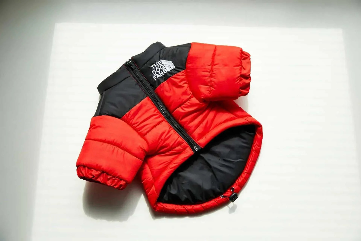 Red and black winter down puffer jacket for dogs with zipper.
