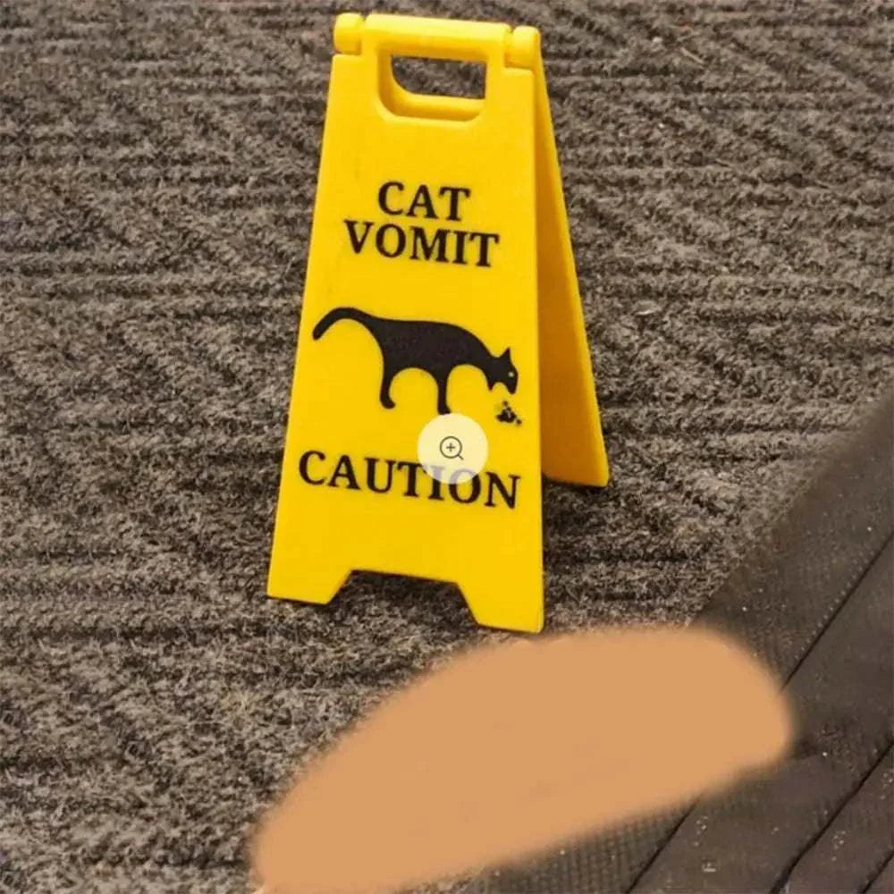 Yellow cat and dog funny warning sign for vomit caution with black silhouette on carpet