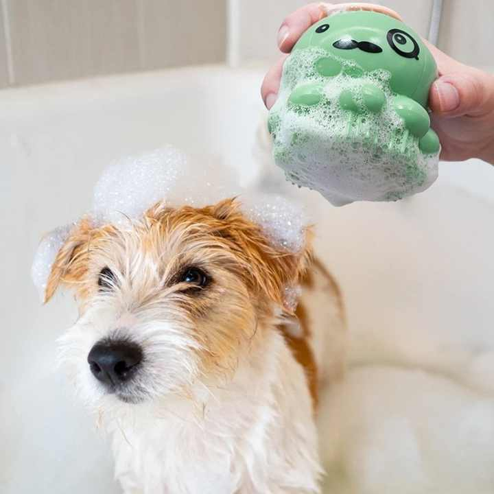Sherloctopus pet bath massager with gentle bristles cleaning a soapy dog in bath