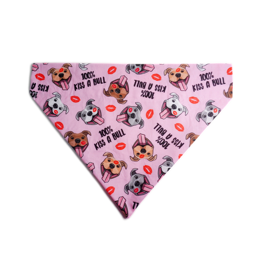 Pink dog bandana with playful 100% Kiss-A-Bull print, made of soft 100% cotton, easy loop collar attachment