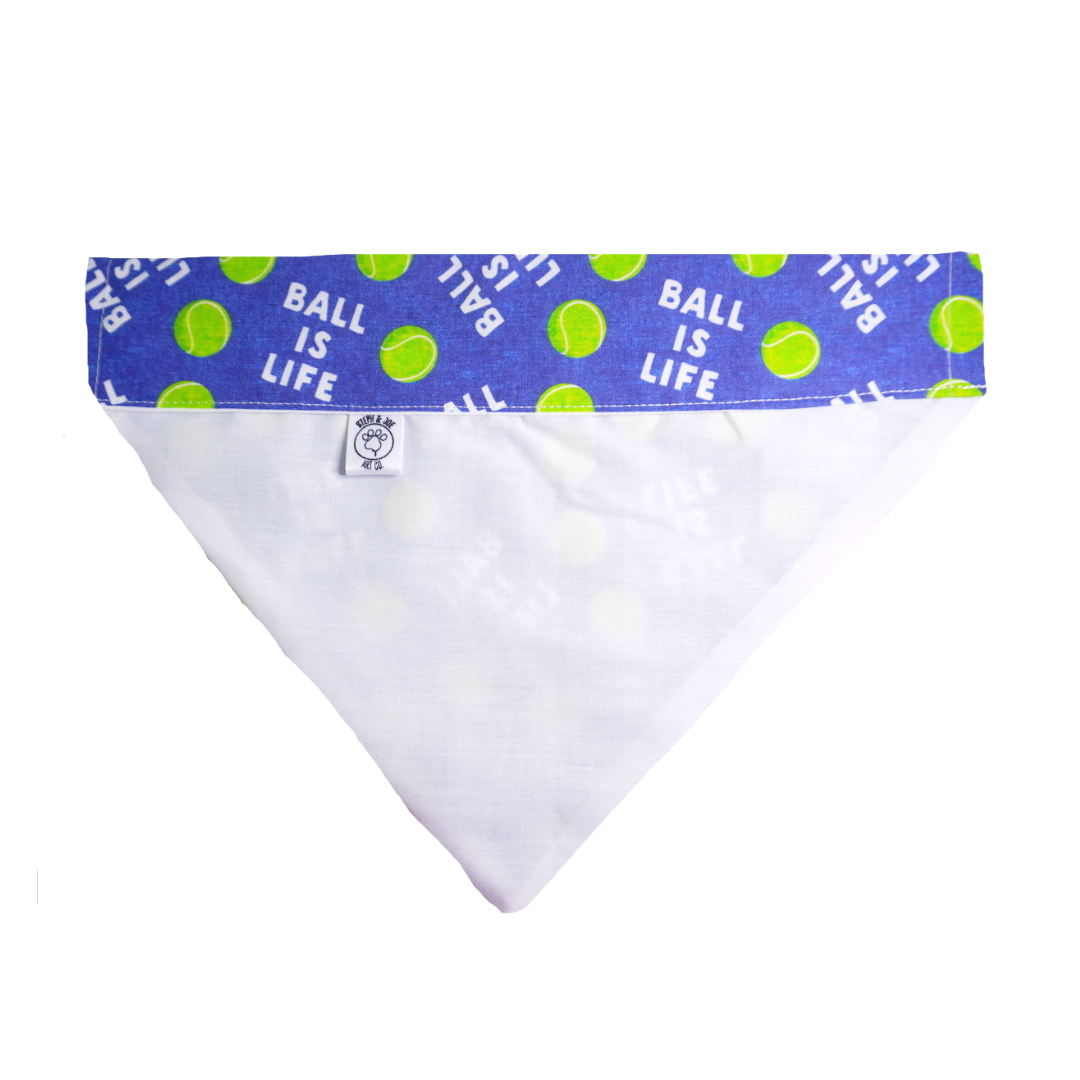 Dog bandana with "Ball is Life" design, featuring tennis balls, made from 100% cotton with Steph & Joe Art Co. logo patch.