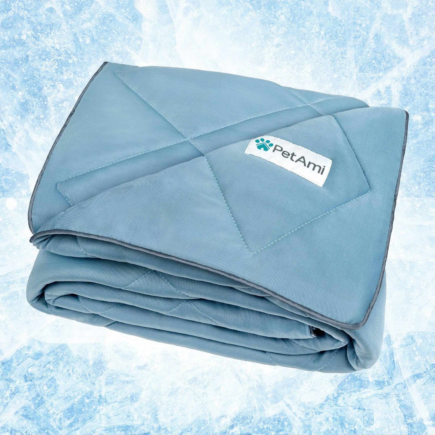 Folded blue cooling pet dog blanket made of soft fabric with PetAmi label against icy background
