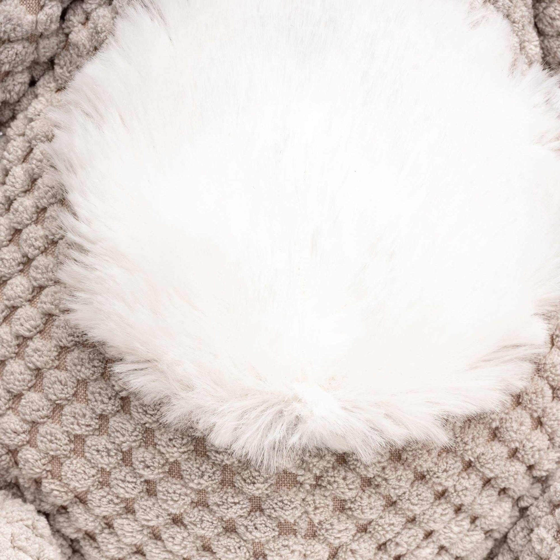 white fluffy dog blanket on knitted beige cushion