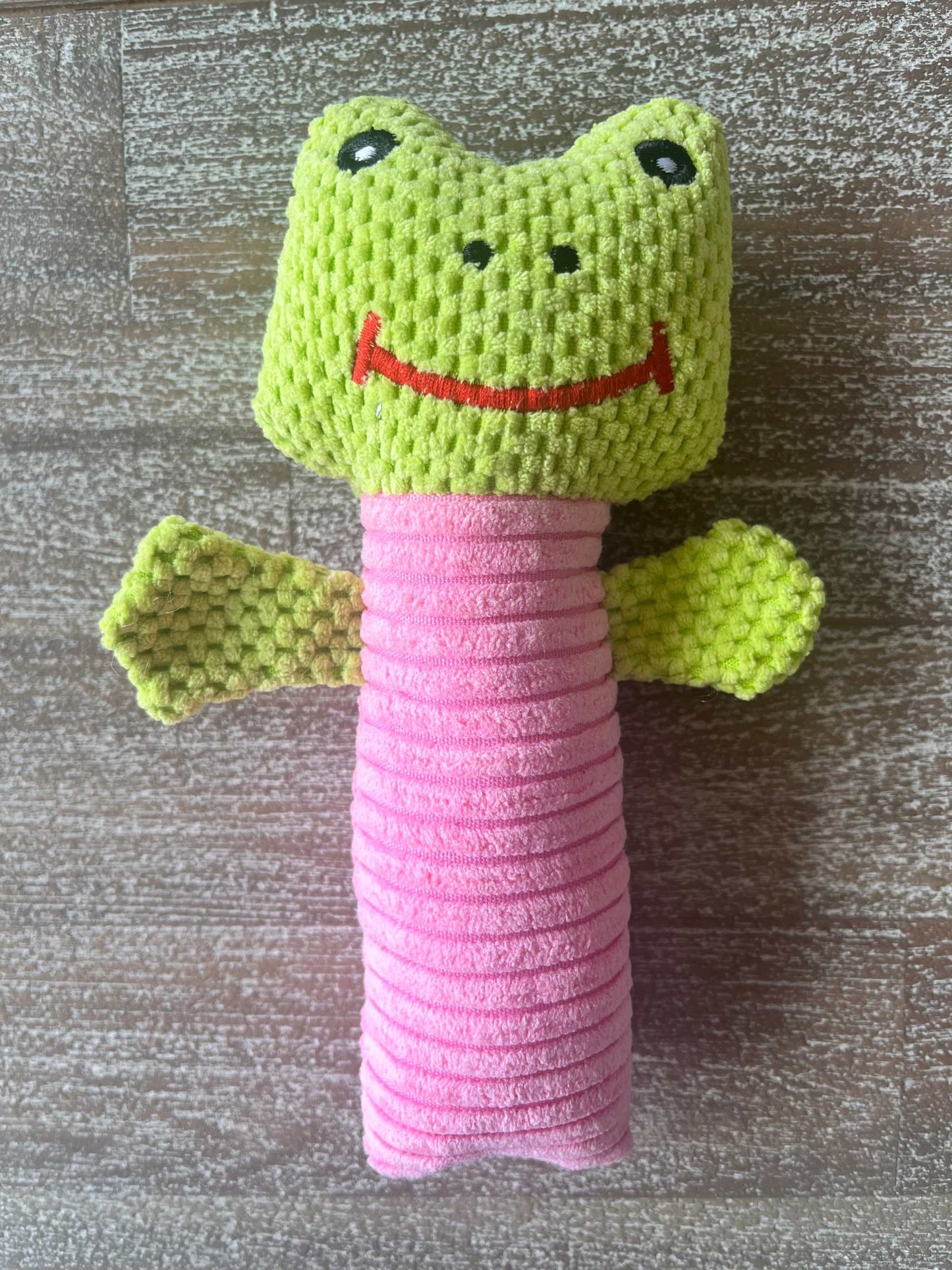 Cute squeeker toy for small dogs shaped like a green and pink frog with textured fabric and squeaker inside