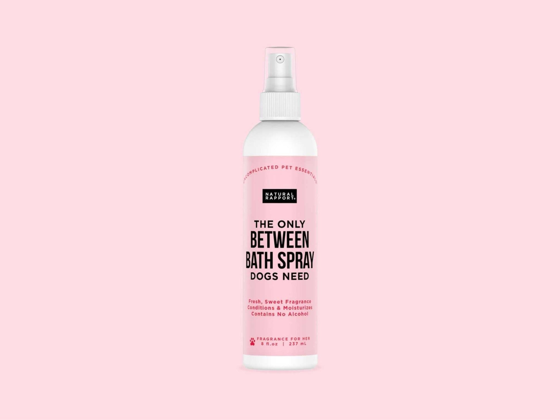 Natural Rapport Bath Spray for Dogs bottle on pink background.