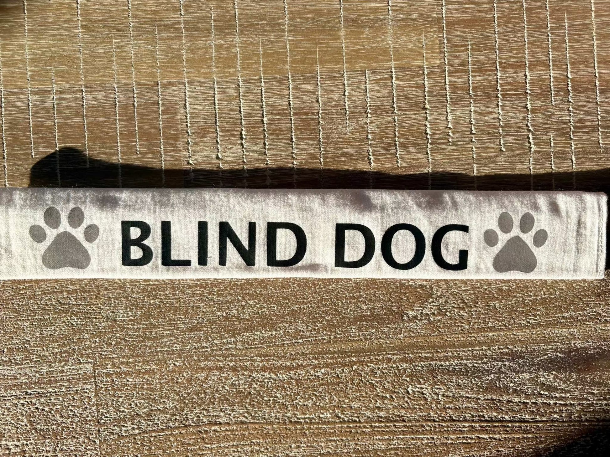 Customizable white cotton lead slip for dogs with "BLIND DOG" text and paw prints, designed for safety and communication.
