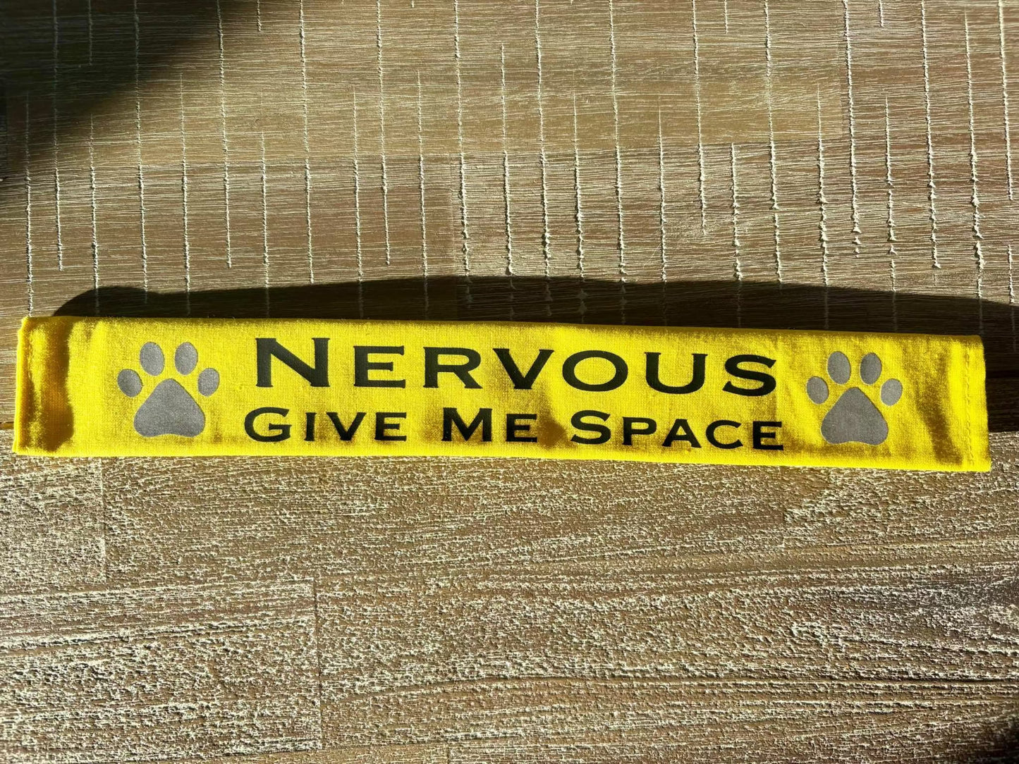 Yellow lead slip for dogs with black text "Nervous Give Me Space" and reflective paw prints.