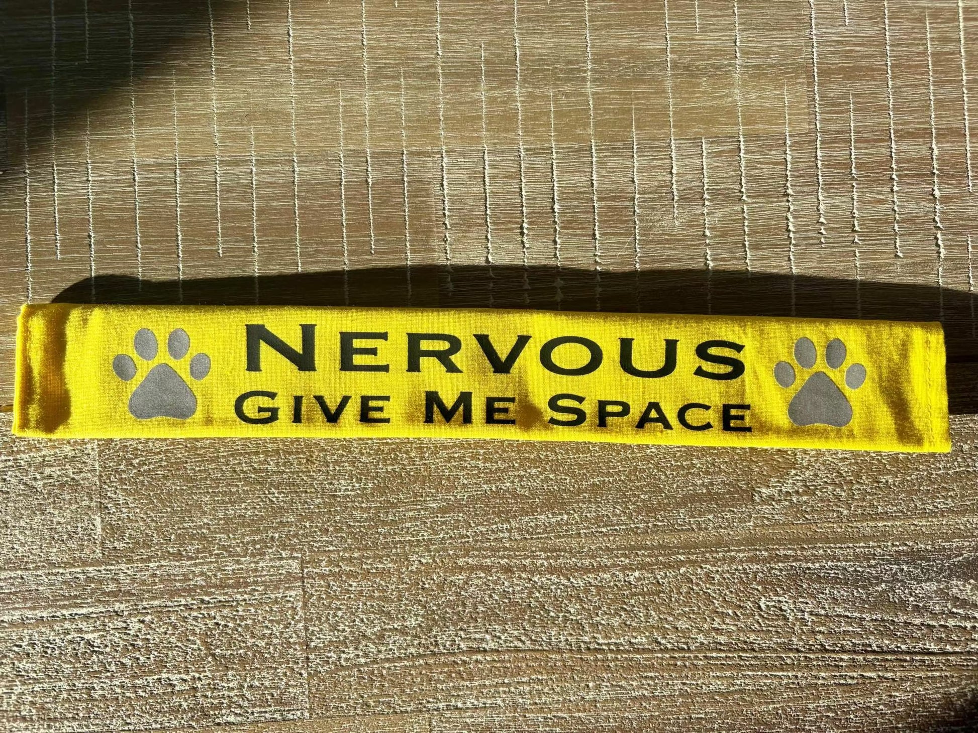 Yellow lead slip for dogs with black text "Nervous Give Me Space" and reflective paw prints.