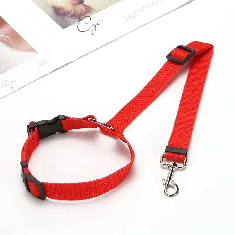 Red single dog seat belt, adjustable car headrest restraint for pet safety.