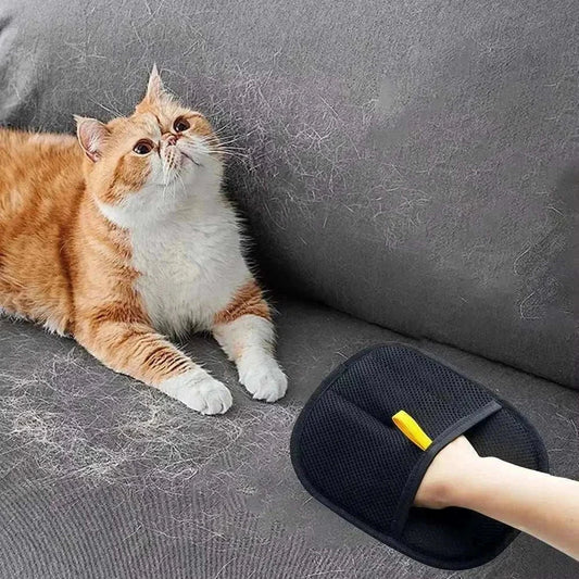 Eco Two-way pet hair removal glove cleaning fur from gray sofa with orange and white cat nearby