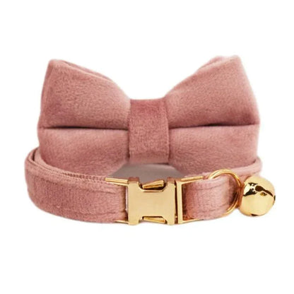Luxury velvet cat collar in soft pink with bow tie, gold buckle, and bell