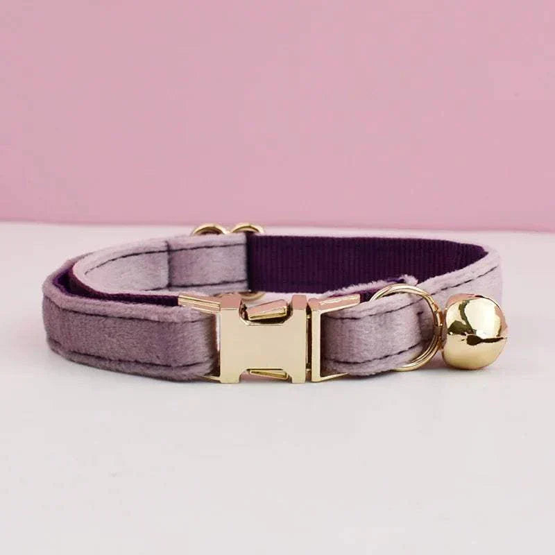 Luxury velvet cat collar with gold bell and adjustable clasp on pink background