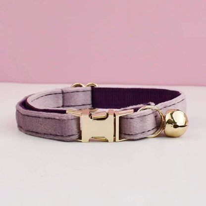 Luxury velvet cat collar with gold bell and adjustable clasp on pink background