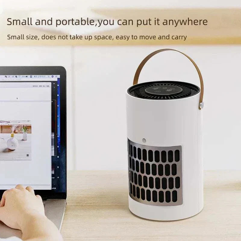 Portable air purifier with HEPA filter and odor control by laptop.