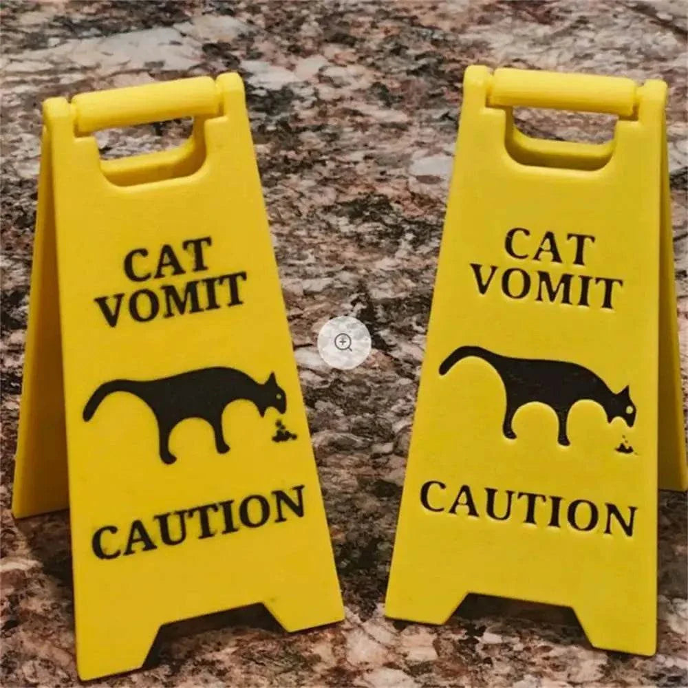 Cat and dog funny warning sign with black silhouettes on bright yellow, humorously cautioning about vomit.