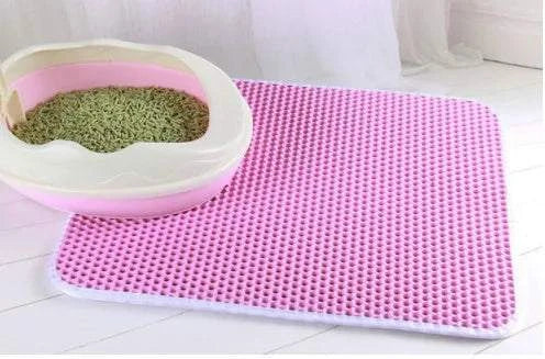 Cat litter mat with double layer honeycomb design, waterproof and urine proof, next to litter box.