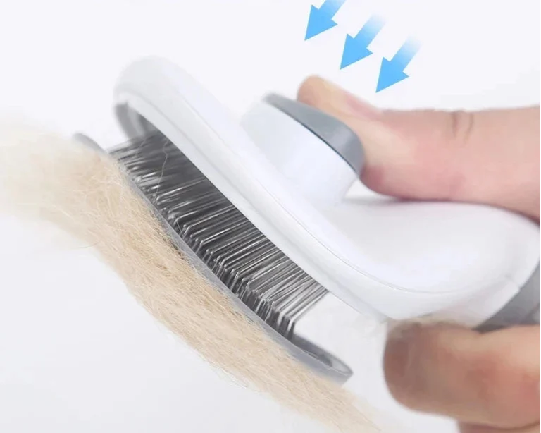 Self cleaning pet grooming tool with stainless steel bristles removing pet fur effortlessly.