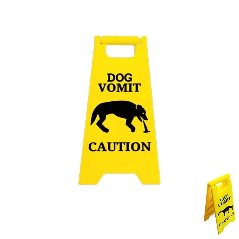 Yellow funny warning sign featuring cat and dog vomiting silhouettes, reads "Dog Vomit Caution," perfect gag gift for pet owners.