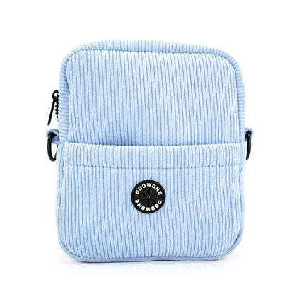 Corduroy velvet dog treat pouch in blue with adjustable strap and built-in poop bag dispenser.