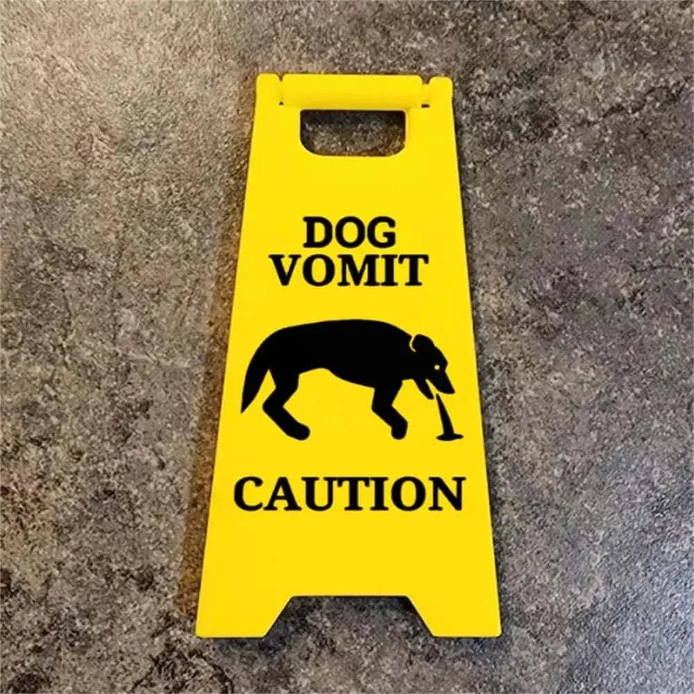 Yellow dog vomit warning sign with silhouette, caution message.