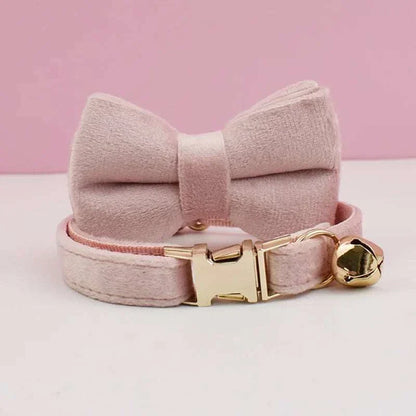 Luxury velvet cat collar in soft pink with bow tie, gold bell, and adjustable buckle