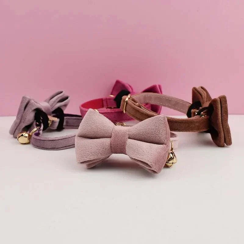 Luxury velvet cat collars with personalized name plate, bell, and bow tie in various colors.