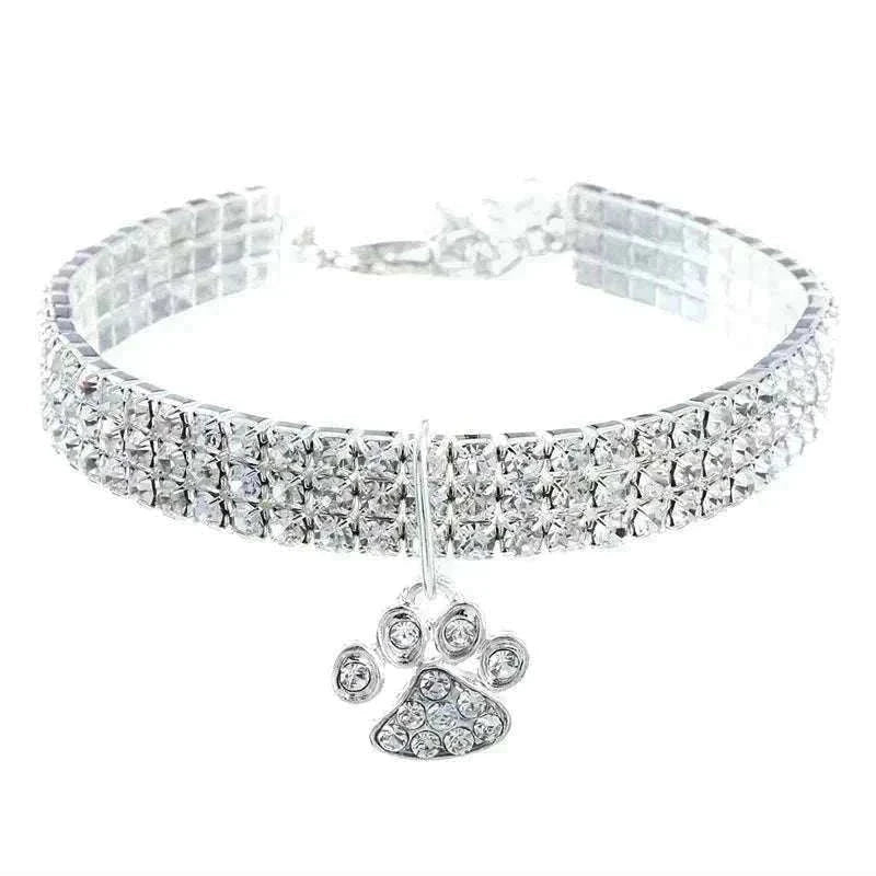 Pretty Kitty's Paw Pendant Cat Collar with a silver-toned band densely set with clear rhinestones and a dangling crystal paw charm